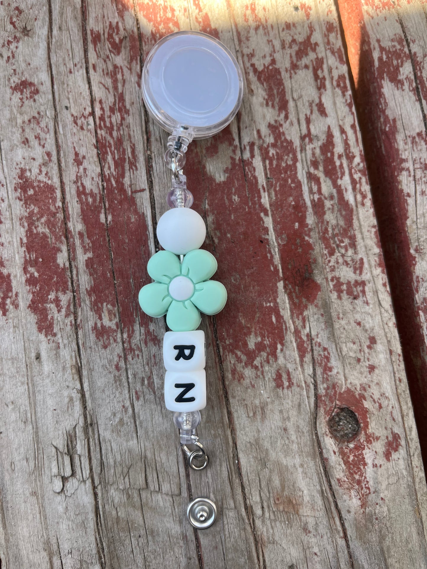 Green flower RN badge reel