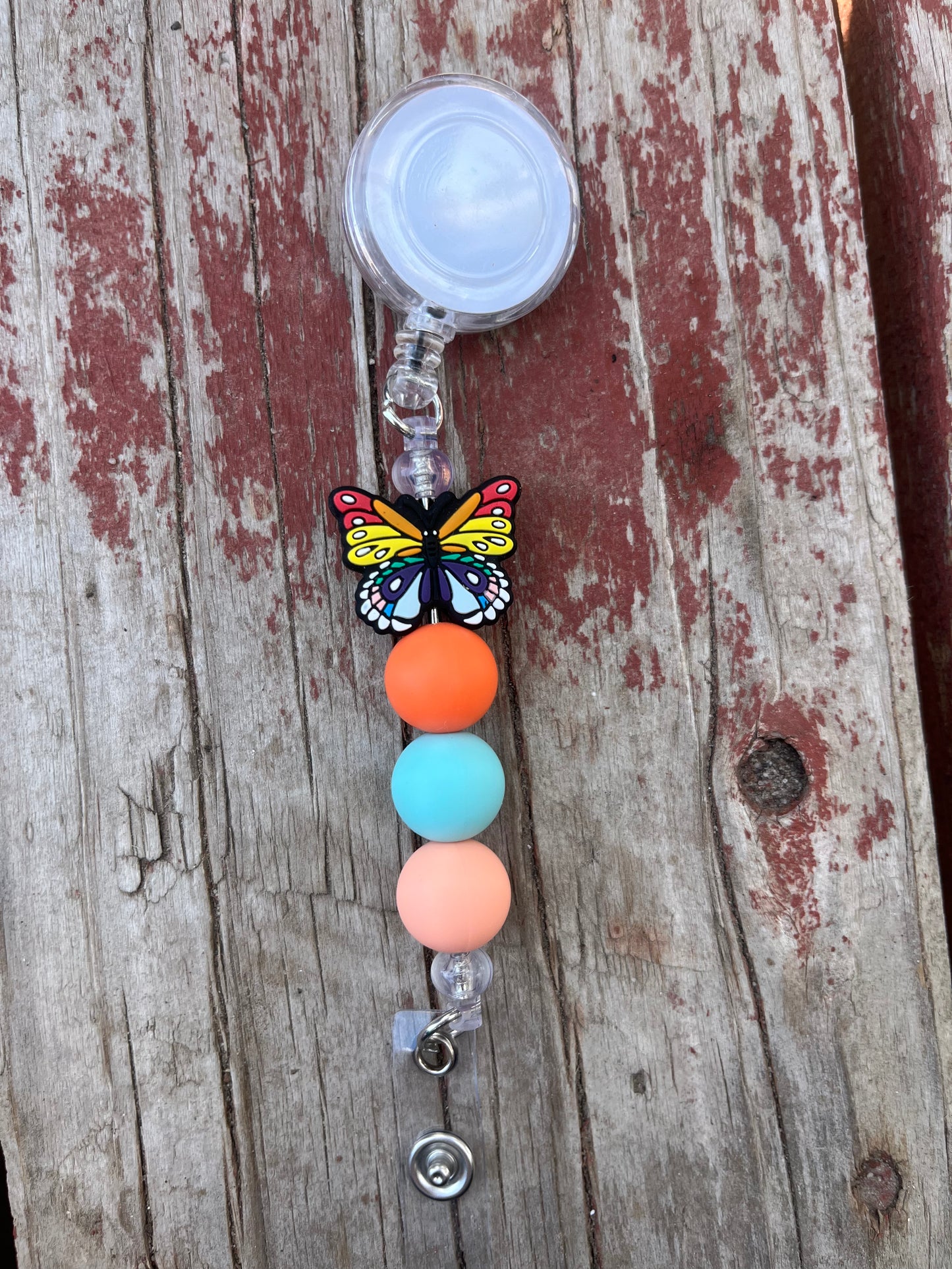 Orange butterfly badge reel