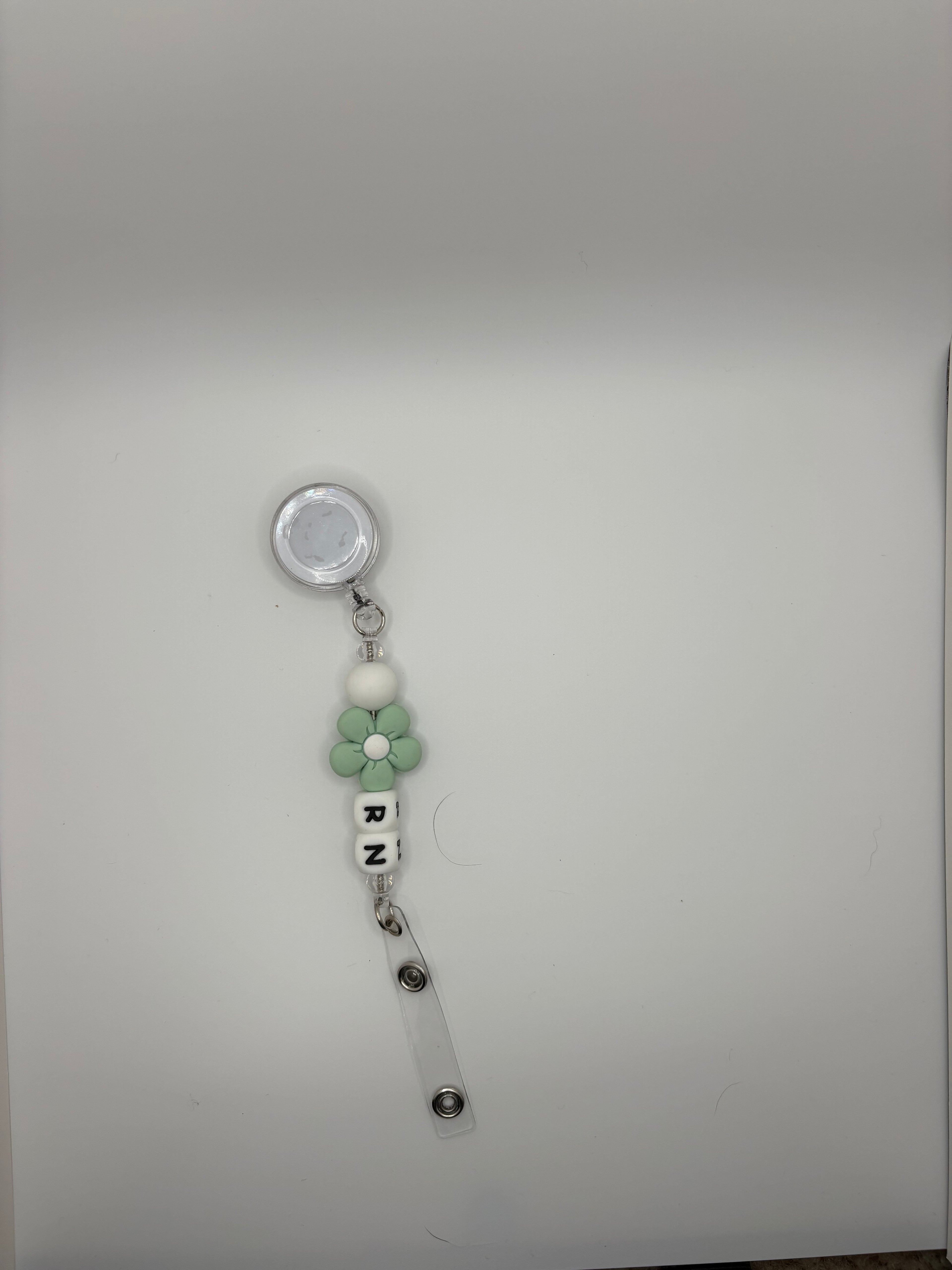 green flower RN badge reel