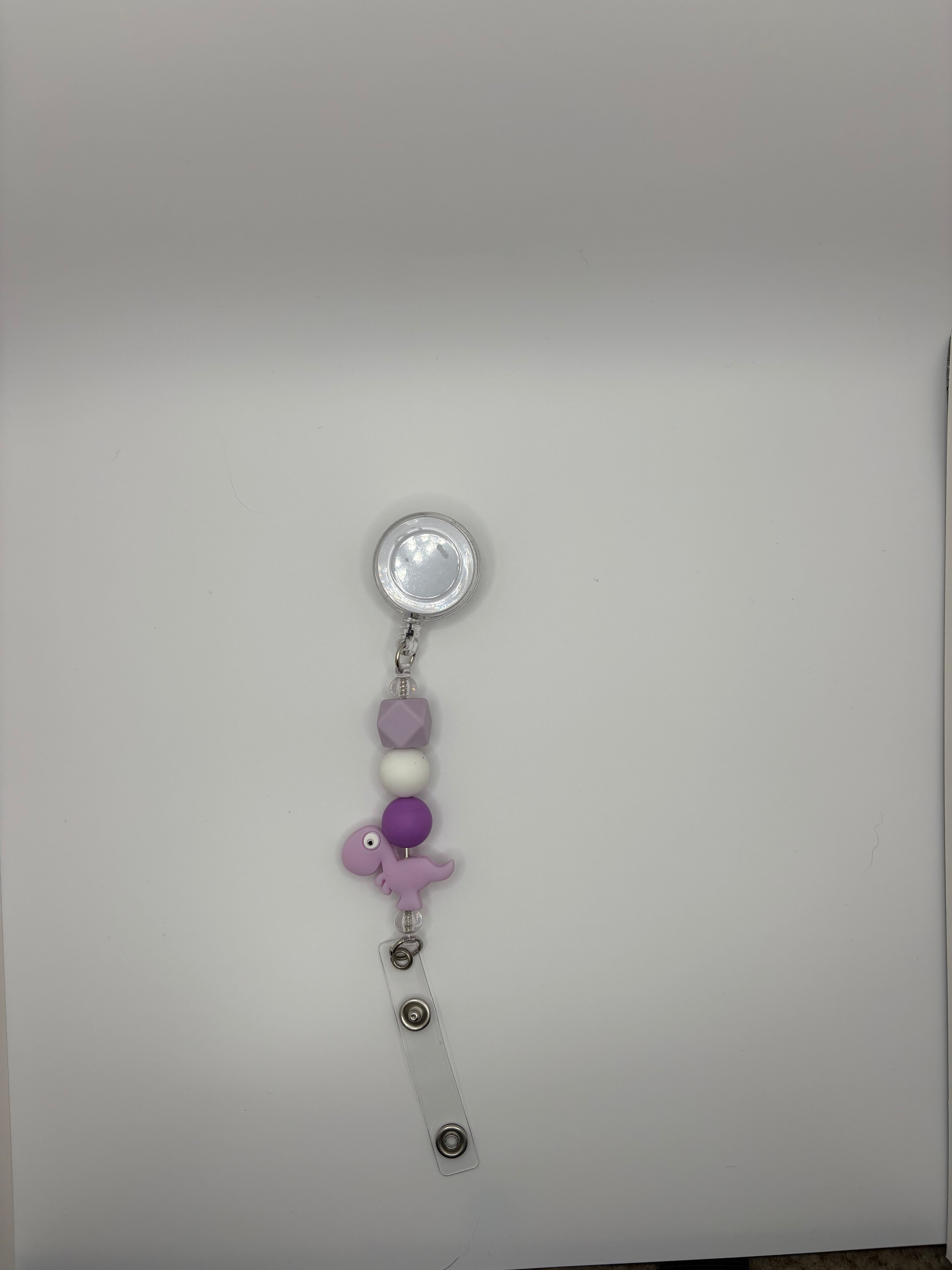purple Dino badge reel